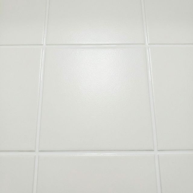 After: Clean white bathroom tiles with pristine epoxy grout